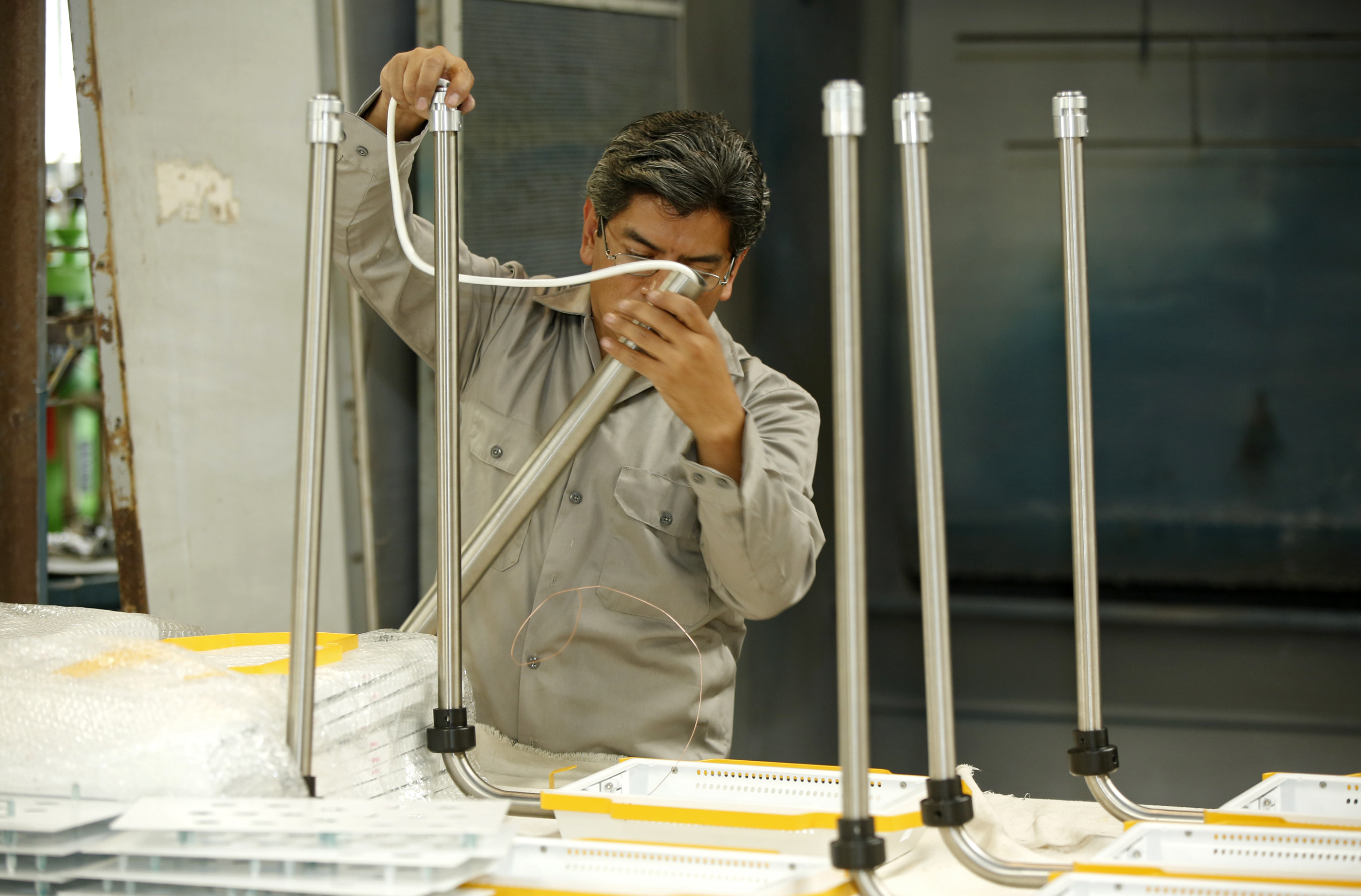 Man working with metal tubes